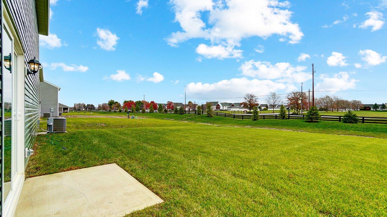 Spacious backyard with a manicured lawn.