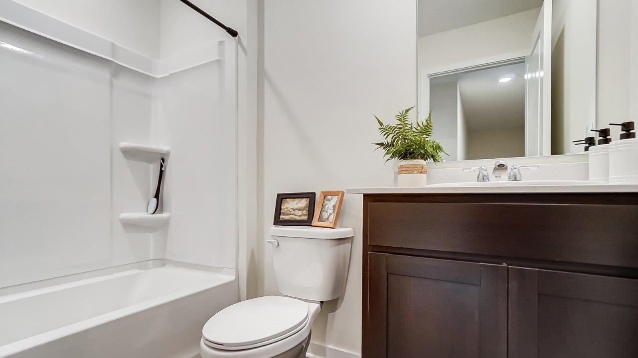 Bathroom featuring a sink, toilet, and shower tub.