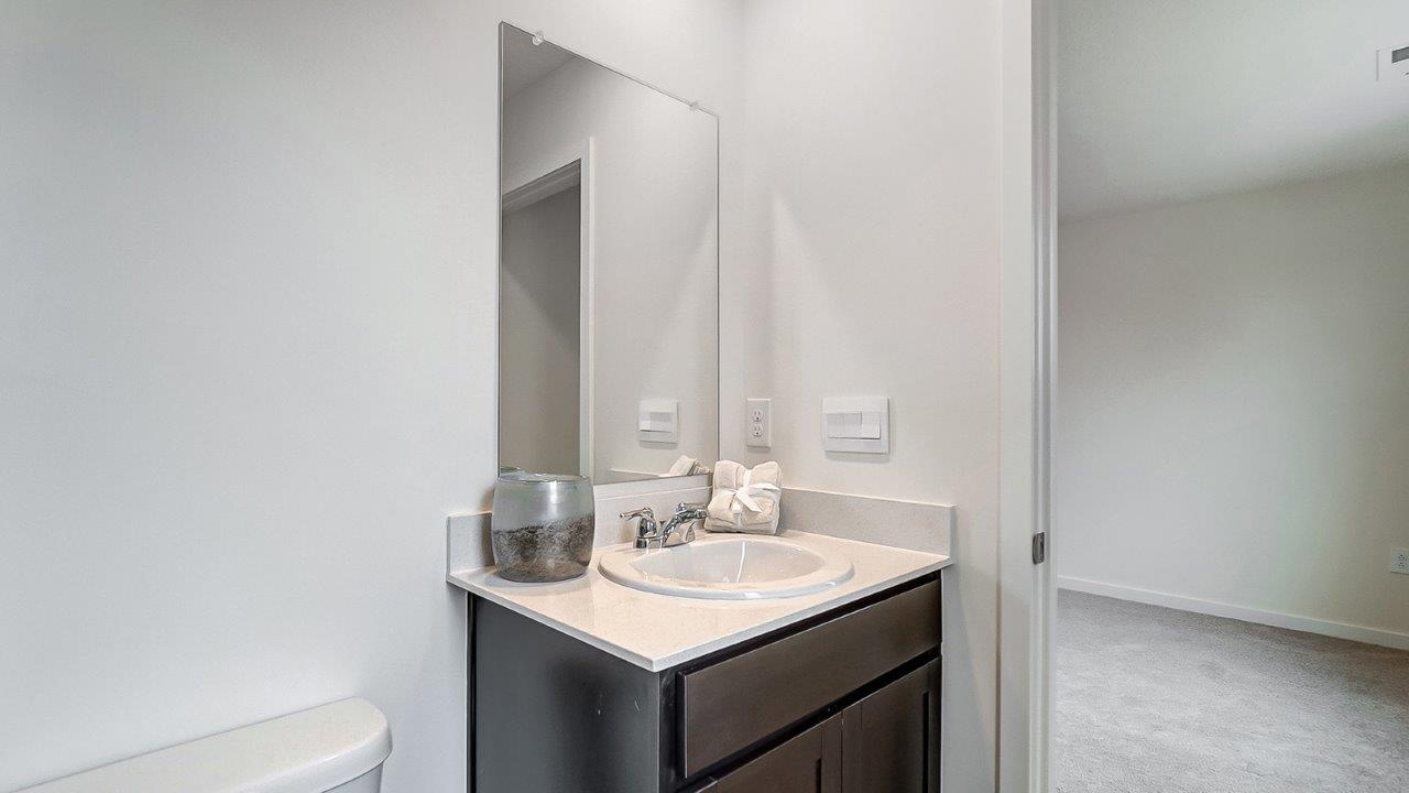 Bathroom with a sink and long mirror above.