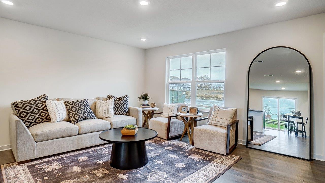 Bright living room with large windows and neutral walls.