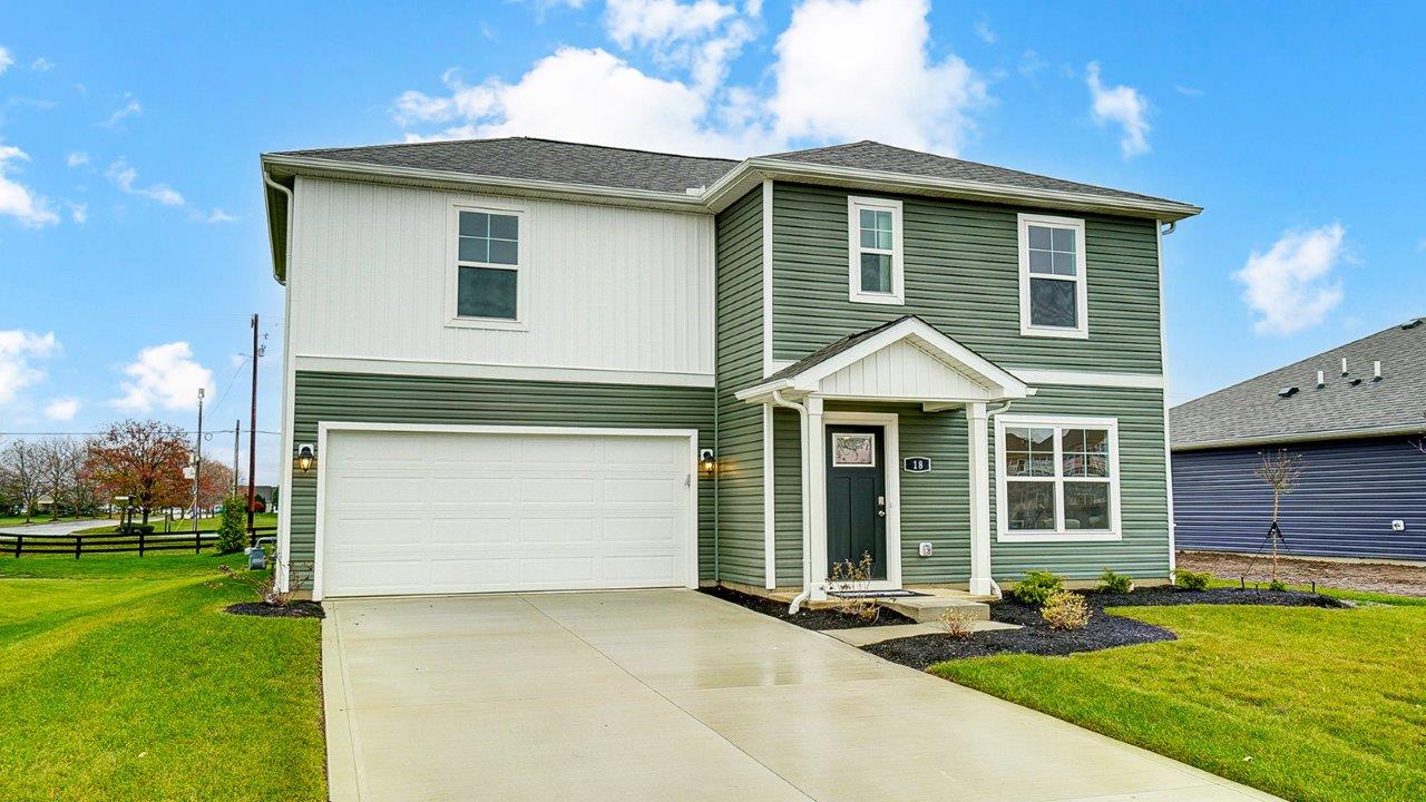 Two story new build home with neutral exterior and a two car garage.