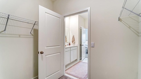 primary walk in closet with wire shelving