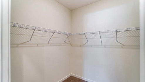 primary walk in closet with wire shelving
