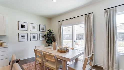 dining space with table and chairs, rear sliding door