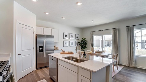 kitchen with walk in corner pantry, built in island with stainless steel appliances