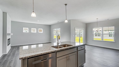 kitchen island with pendant lights and stainless steel sin