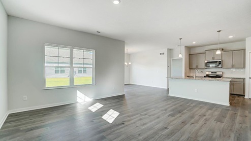 great room with double window and kitchen