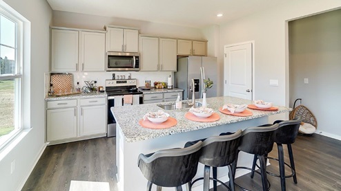 kitchen with grey cabinets, island and barstools