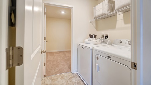 laundry room with attached walk in closet