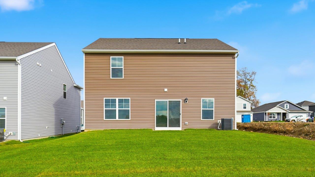 two story home with brown siding rear exterior