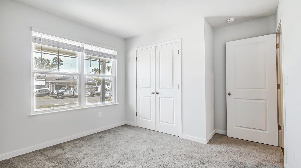second bedroom with closet and entry