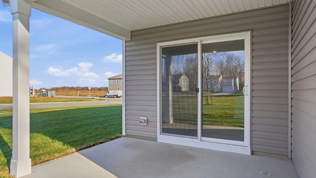 covered rear patio with sliding door