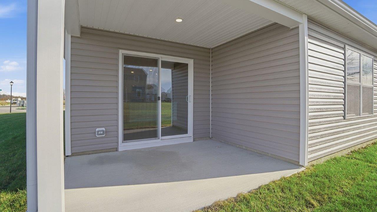 covered rear patio with sliding door