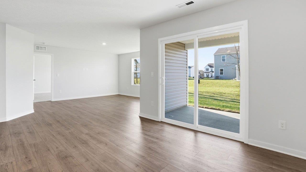 dining space with rear sliding door and great room
