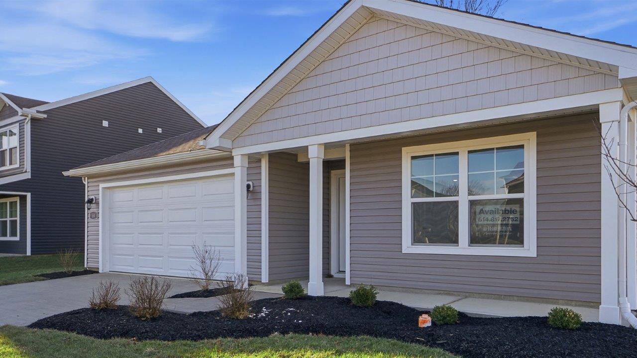 single story home with grey siding, covered front porch and two car garage
