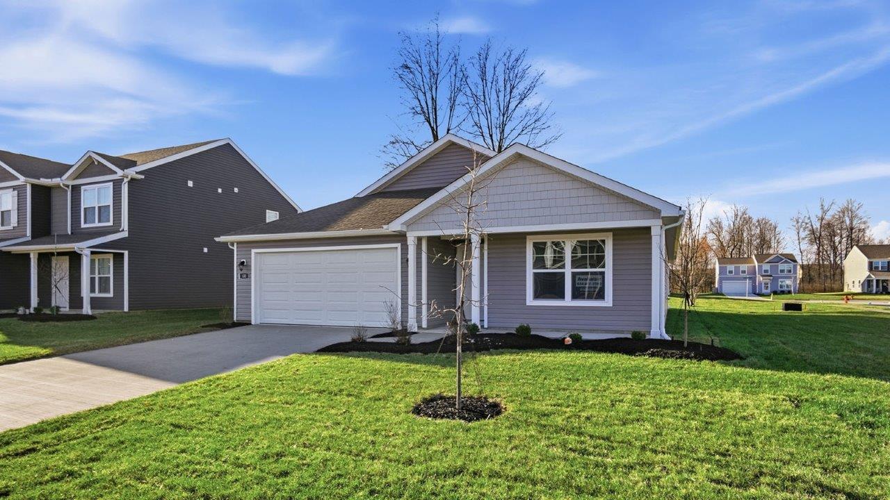 single story home with grey siding, covered front porch and two car garage