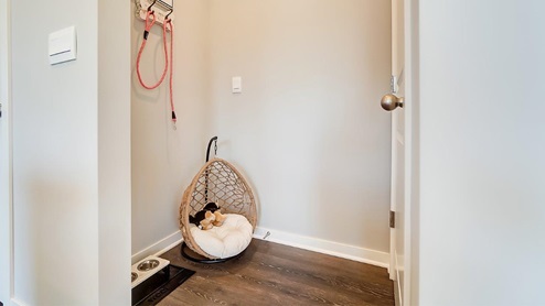 model home garage entry with dog bed
