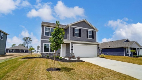 two story home with grey siding, covered entry, two car garage