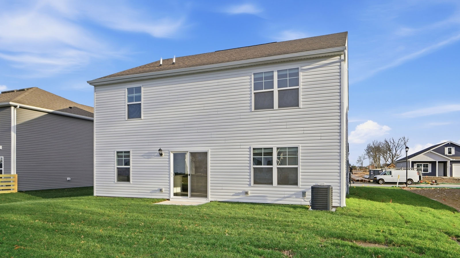 two story home with grey siding rear exterior angle