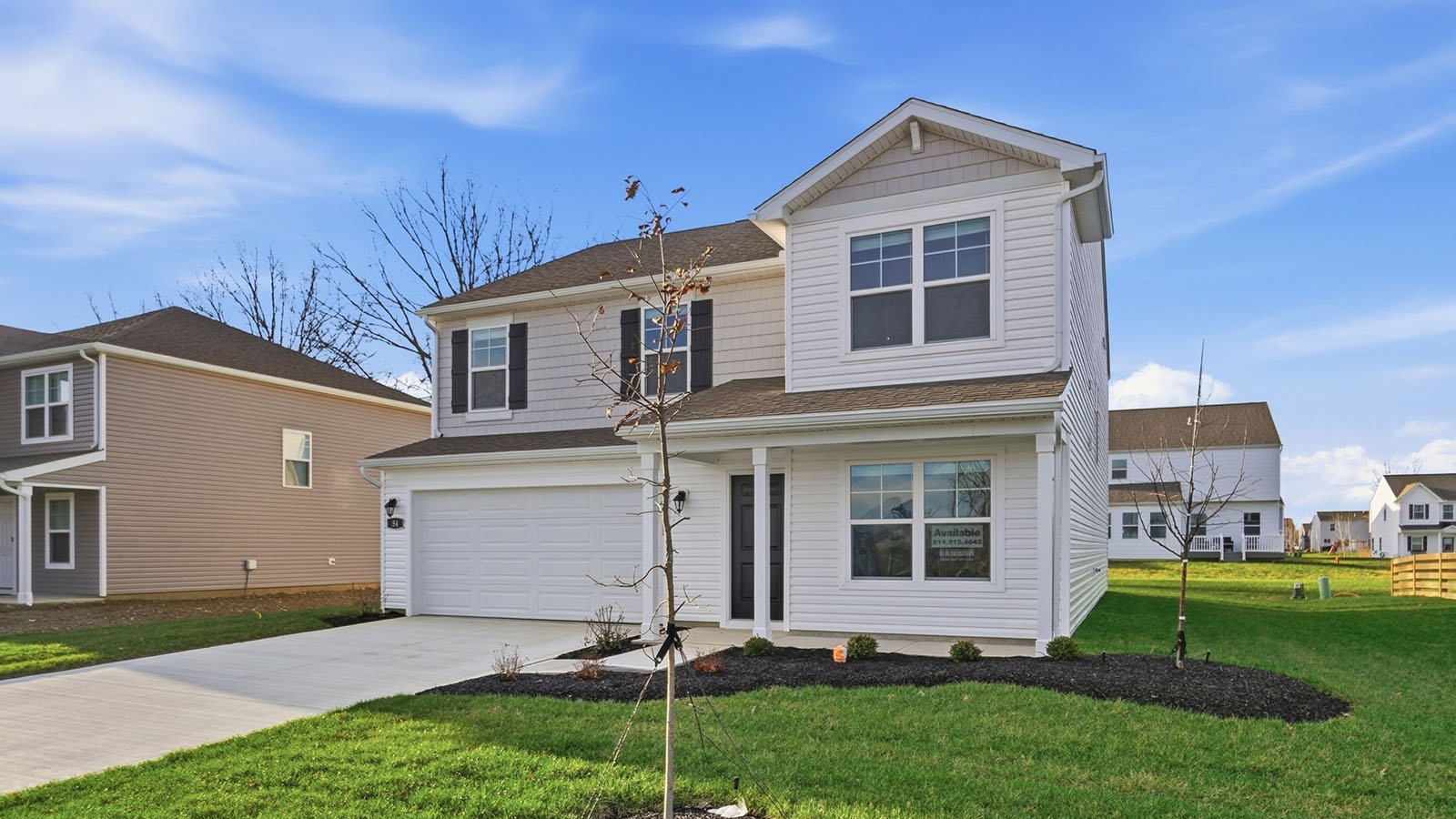 two story home with grey siding, black shutters, covered front porch and two car garage