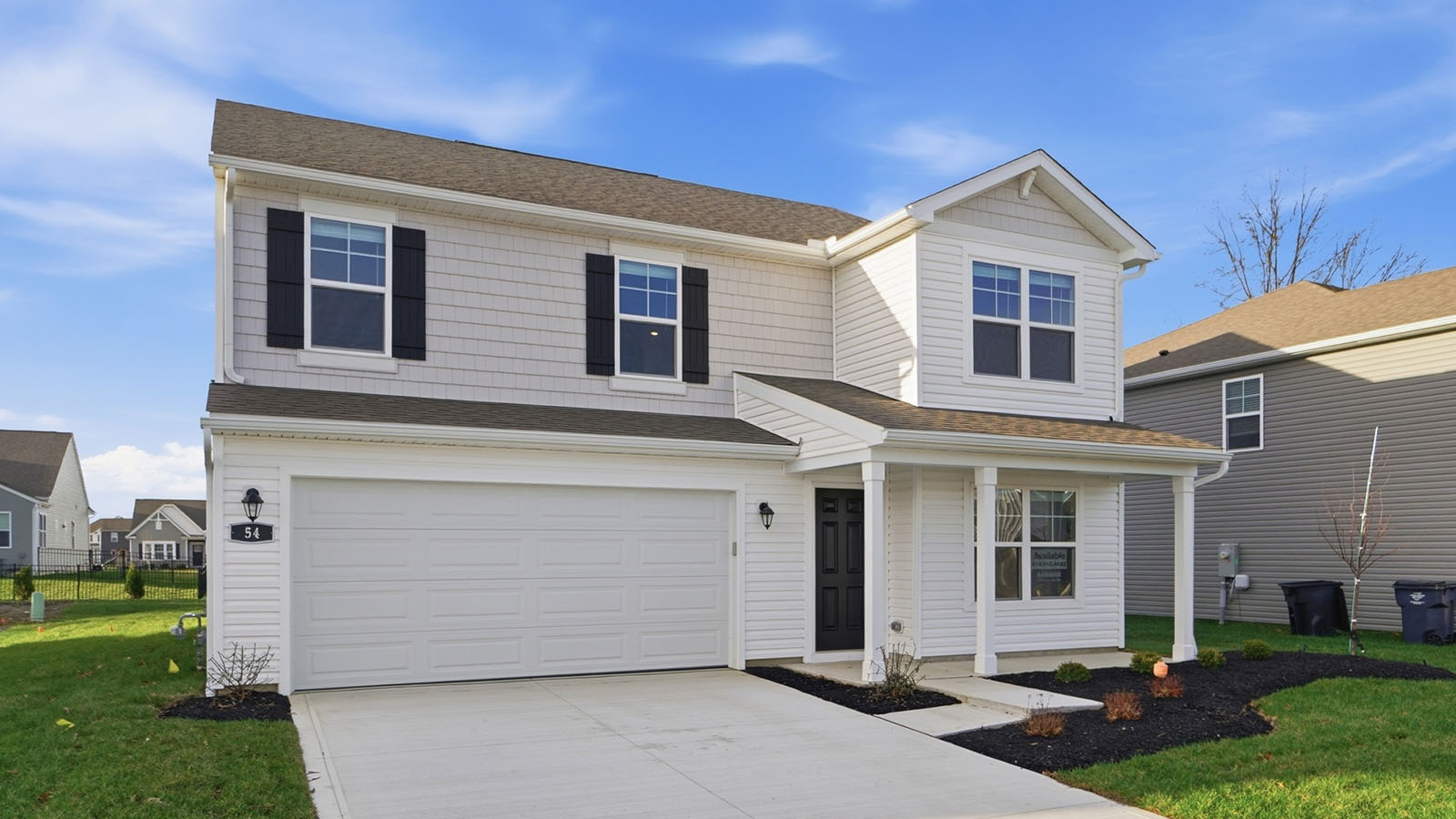 two story home with grey siding, black shutters, covered front porch and two car garage