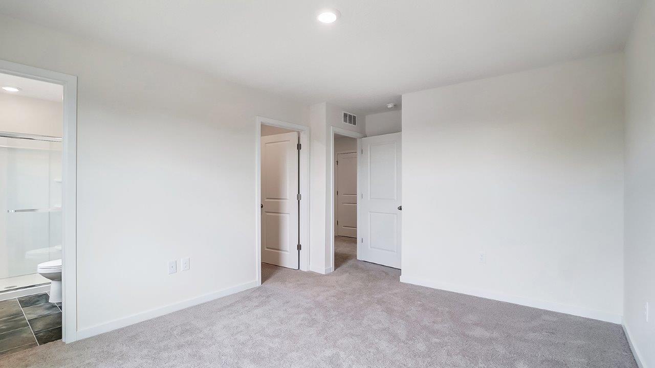 primary bedroom with ensuite and walk in closet