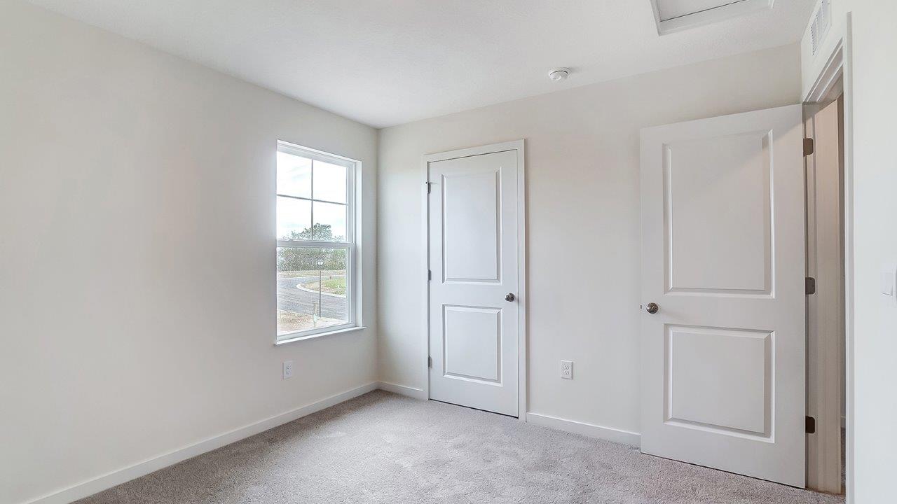 second bedroom with window, closet and entry