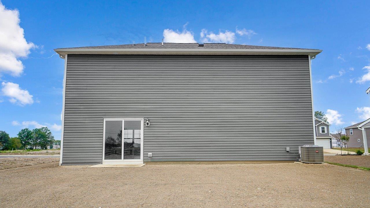 two story home with grey siding rear exterior