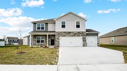 two story home with grey siding, partial stone front, covered front porch and three car garage