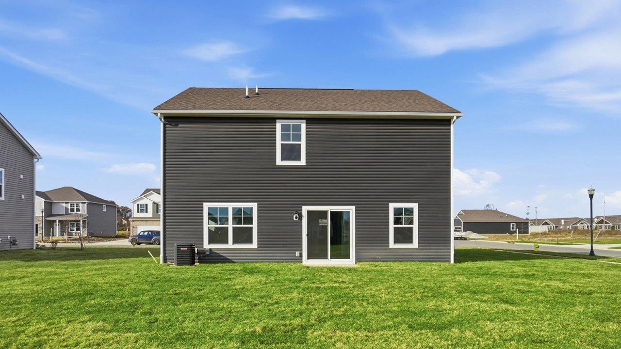 two story home with grey siding rear exterior