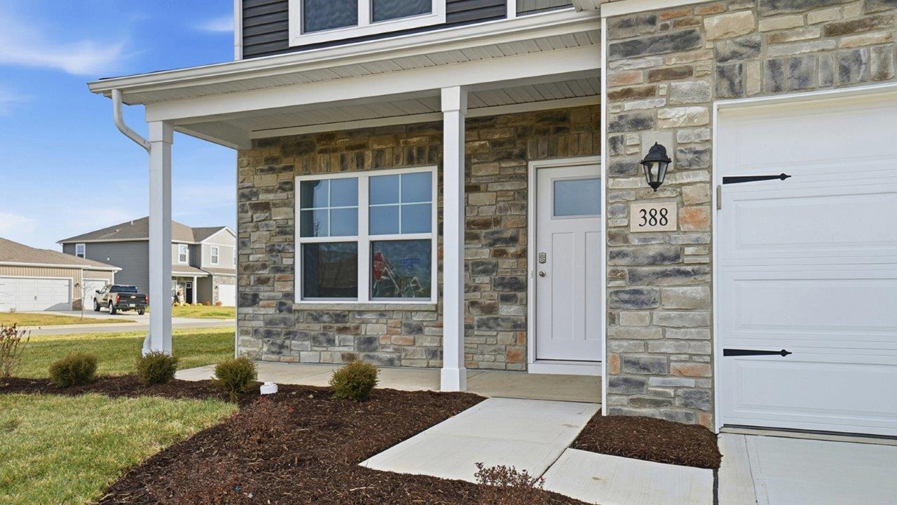 covered front porch with partial stone