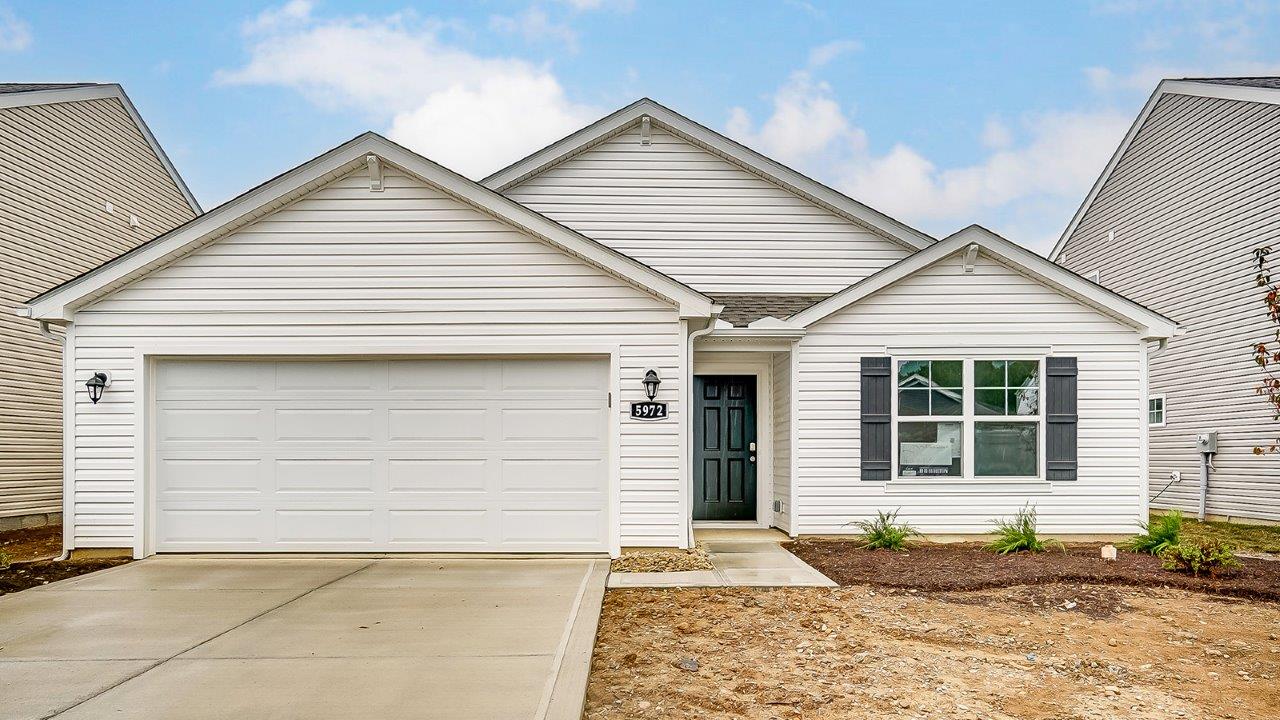 single story home with white siding and 2 car garage
