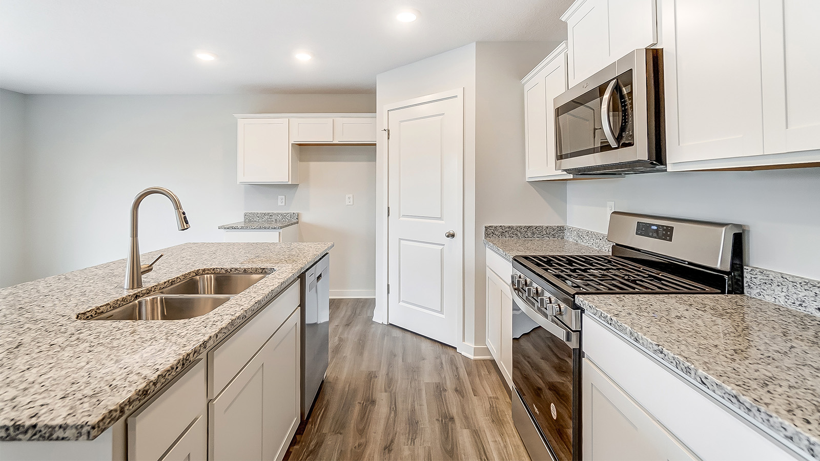 kitchen with island, grey cabinets and walk in pantry