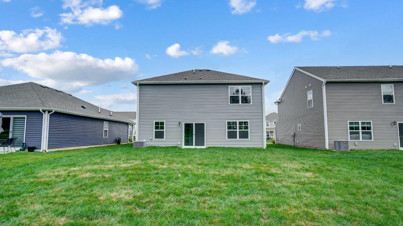 two story home with grey siding rear exterior