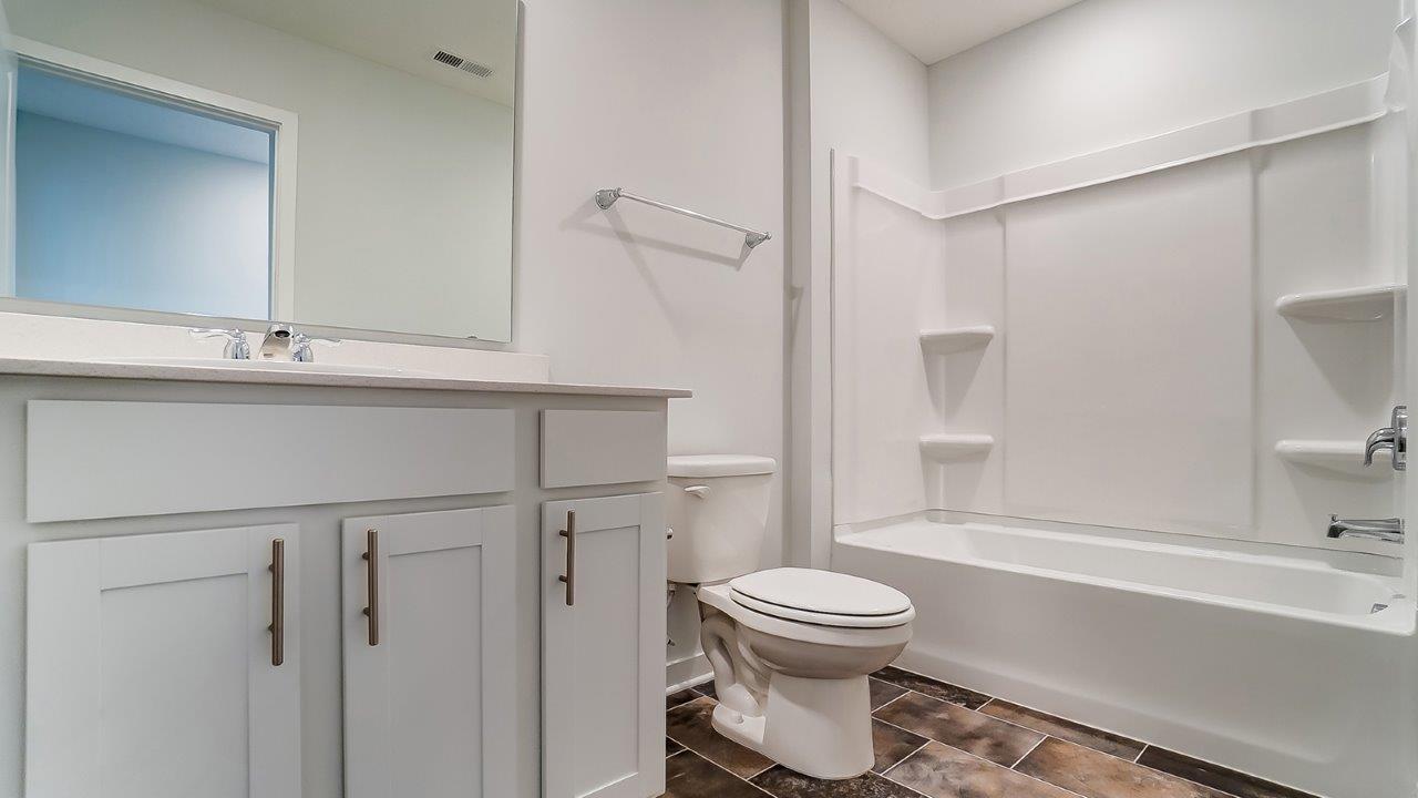 second full bath with single vanity, toilet and bath tub