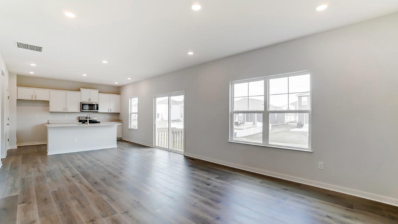 great room with double window and kitchen