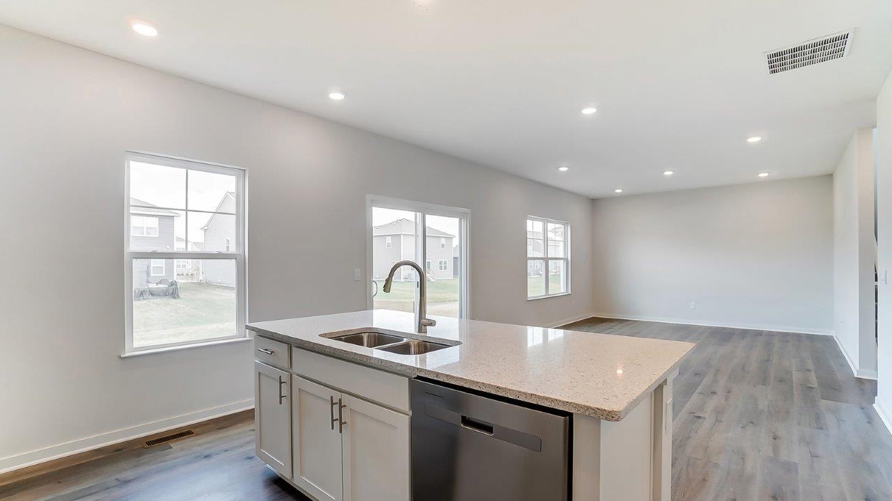 built in island and great room with single windows, rear sliding door