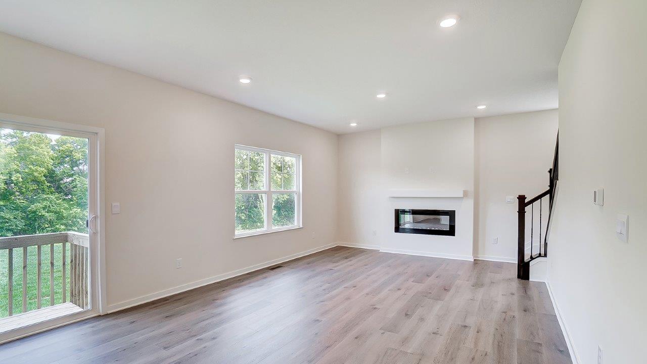 great room with electric fireplace and double window