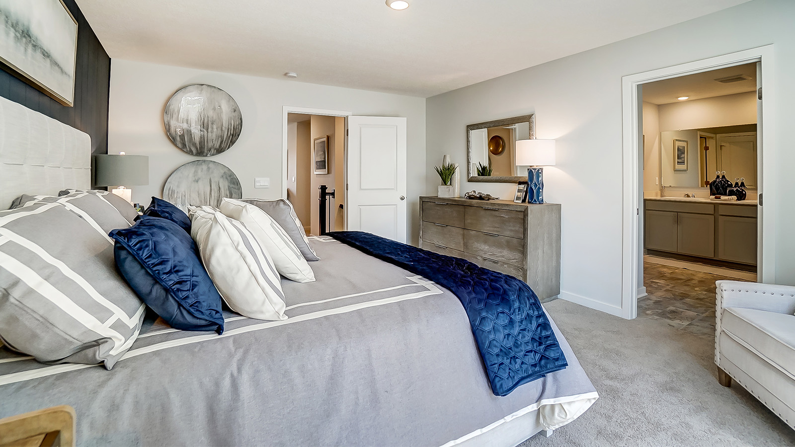 furnished primary bedroom entry and ensuite