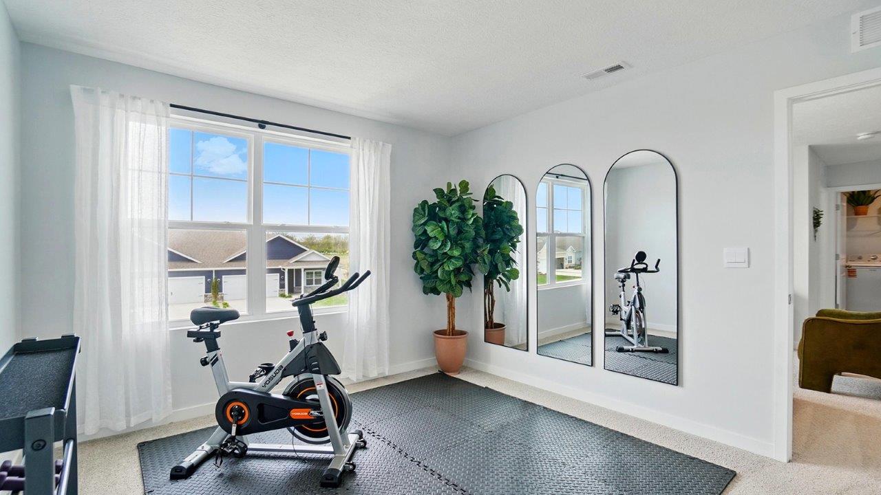 home gym with a large window, and exercise equipment