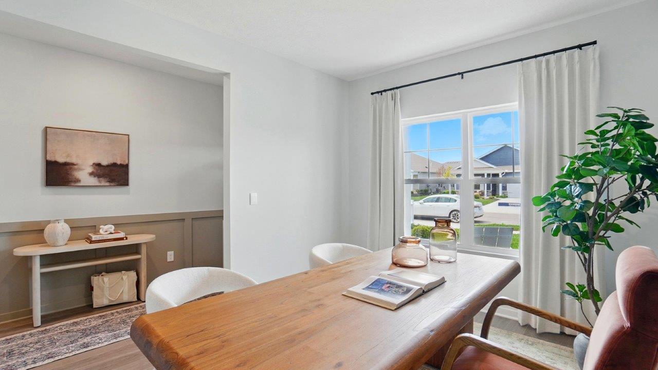formal dining room off of the entrance of the home featuring a rectangle wood table and a large window