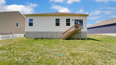 single story home with white siding rear exterior
