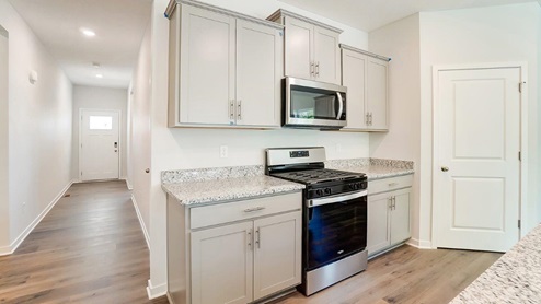 grey cabinets, stainless appliances, walk in pantry