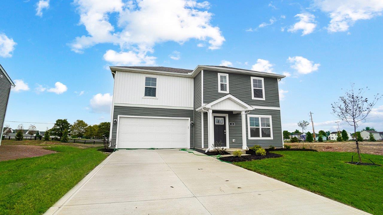 Two story home with grey and white siding and two car garage