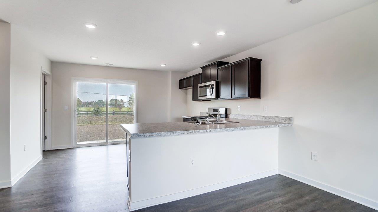 kitchen with brown cabinets, attached island and rear sliding door