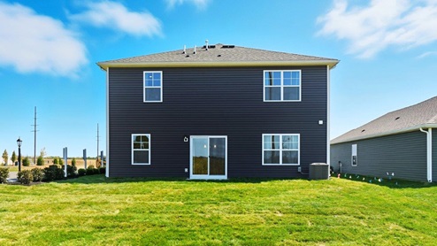 two story home with blue siding rear exterior