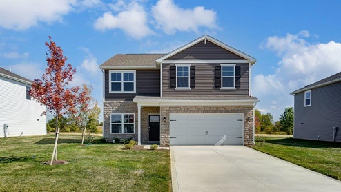 two story home with brown siding, covered entry and two car garage