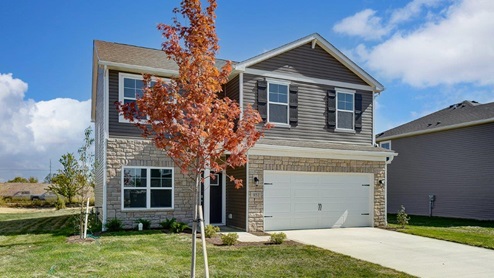 two story home with brown siding, covered entry and two car garage angle