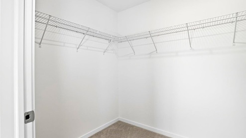 primary walk in closet with wire shelving