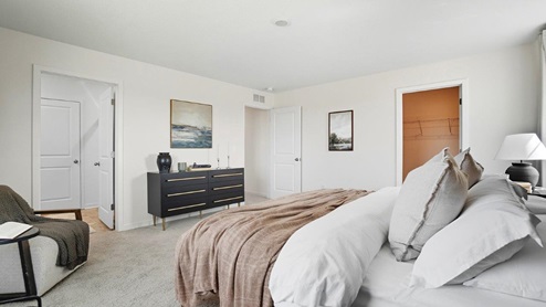 furnished primary bedroom entry and ensuite bath